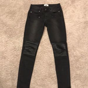 Distressed black jeans with leather details